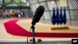 In-house cameras and a microphone are set up at the arrivals area for EU leaders at the European Council building in Brussels, July 16, 2020.