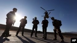 FILE - American soldiers wait on the tarmac in Logar province, Afghanistan in this Nov. 30, 2017 photo. (AP Photo)