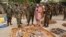 Officials stand near ammunition seized from suspected members of Hezbollah after raid of building in Kano, Nigeria, May 30, 2012