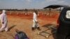 Funeral workers wearing personal protective equipment are seen after a burial South Africa