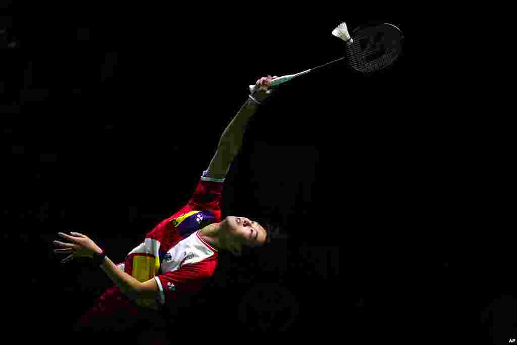 Taiwan&#39;s Pai You Po returns a shot to Japan&#39;s Sayaka Takahashi during their women&#39;s badminton singles match at the BWF World Championships in Huelva, Spain.