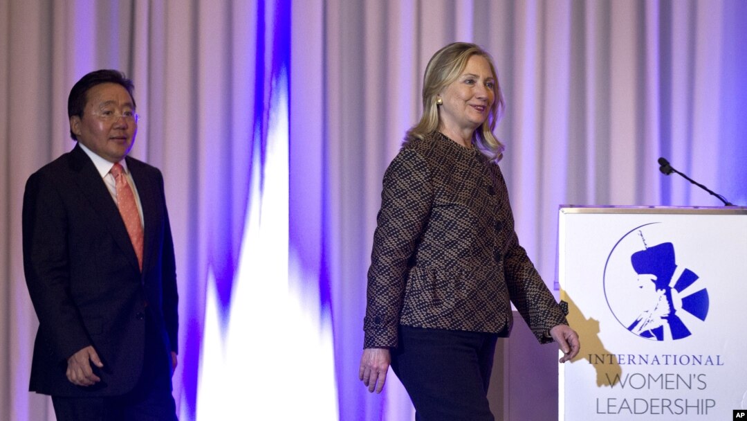 U.S. Secretary of State Hillary Rodham Clinton, right, and Mongolian President Elbegdorj Tsakhia arrive at the International Women's Leadership Forum held inside Parliament in Ulaanbaatar, Mongolia, July 9, 2012. 