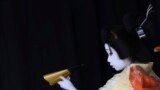 An elementary school boy acting as an young woman performs during a show of an amateur children kabuki theatrical company in Tokyo, Japan.