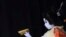 An elementary school boy acting as an young woman performs during a show of an amateur children kabuki theatrical company in Tokyo, Japan.