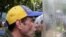 Venezuelan opposition leader Henrique Capriles talks to riot police during a rally to demand a referendum to remove President Nicolas Maduro in Caracas, Venezuela, June 7, 2016. 
