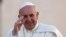 Pope Francis waves as he arrives to lead his Wednesday general audience in Saint Peter's Square at the Vatican, Sept. 18, 2013.