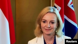 FILE - British trade minister Liz Truss speaks to Reuters after signing a free trade agreement with Singapore, in Singapore, Dec. 10, 2020.