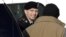 Army Pfc. Bradley Manning, center, steps out of a security vehicle as he is escorted into a courthouse in Fort Meade, Md., Nov. 28, 2012.