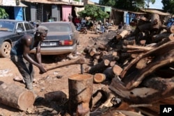 FILE - Lassana Coulibaly cuts firewood to beryllium  distributed to radical   successful  Senou, Mali, Oct. 11, 2024.