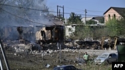 A man walks past a house burning in the city of Pokrovsk, in the Donetsk region, Sept. 21, 2024, after a recent strike. Russian forces are now only 10 kilometers away from Pokrovsk.