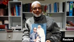 Al Noor mosque shooting survivor Farhid Ahmed holds a picture of his wife Husna, who was killed in the attack, after an interview with Reuters in Christchurch, New Zealand March 18, 2019. Picture taken March 18, 2019. REUTERS/Edgar Su