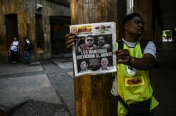 A vendor sells newspapers in Medellin, Aug. 30, 2019, fronted with pictures of former senior commander of the dissolved FARC rebel army group in Colombia, Ivan Marquez, a day after he announced he was taking up arms again along with other guerrillas.