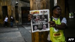 A vendor sells a newspaper in Medellin, Aug. 30, 2019, fronted with pictures of former senior commander of the dissolved FARC rebel army group in Colombia, Ivan Marquez, a day after he announced he was taking up arms again along with other guerrillas.