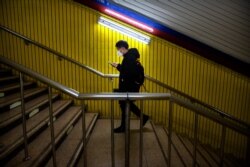 A man wearing a face mask walks through a normally busy subway station during the morning rush hour in Beijing, Feb. 3, 2020.