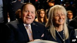 FILE - Chief Executive of Las Vegas Sands Corporation Sheldon Adelson sits with his wife Miriam waits for the presidential debate between Democratic presidential nominee Hillary Clinton and then-Republican presidential nominee Donald Trump at Hofstra Univ