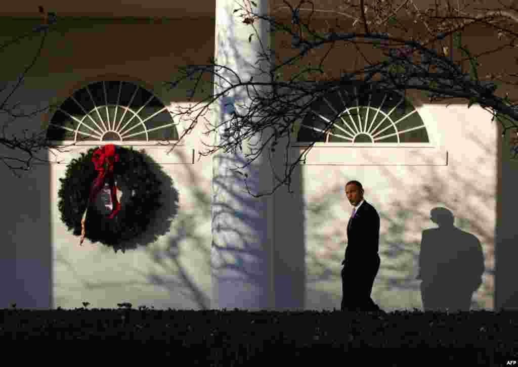 President Barack Obama whistles as he walks along the Colonnade of the White House following a holiday reception, Dec. 14. (Pete Souza/White House)