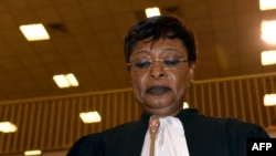 FILE - Chadian human rights activist and coordinator of defense counsel Jacqueline Moudeina stands in the courtroom during proceedings of the trial of Chadian dictator Hissene Habre, in Dakar, on July 20, 2015.