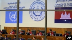 Extraordinary Chambers in the Courts of Cambodia, court officers of the U.N.-backed war crimes tribunal are seen through windows during a hearing of former Khmer Rouge top leaders in Phnom Penh, Cambodia, Oct. 2011 file photo. 