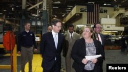 El secretario del Tesoro, Timothy Geithner (izquierda) visita la fábrica de Ford en Chicago. Dijo que la economía de Estados Unidos ha mejorado notablemente.