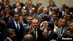 Turkey's Prime Minister Tayyip Erdogan greets ruling AK Party members, party headquarters, Ankara, June 25, 2014.