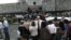 People gather in front of Costa Rica's Supreme Court building, after being evacuated from their respective buildings following a 7.9 magnitude earthquake that shook the region, in San Jose, Costa Rica, September 5, 2012.