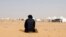 FILE - A Tunisian protester prays during a sit-in at the Kamour oilfield, demanding jobs and a share in revenue from the area's natural resources, near the town of Tatouine, Tunisia, May 11, 2017. 
