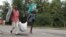 Burundians carry their belongings in Bujumbura, Burundi, Nov. 7, 2015. Carrying their prized possessions, scores of people have fled Burundi’s capital before a security crackdown.