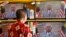 A customer watches a live broadcast of an announcement by Malaysian Prime Minister Najib Razak in Kuala Lumpur, Malaysia, April 6, 2018. Malaysia's Prime Minister Najib Razak says he will dissolve Parliament, paving the way for general elections expected to be held next month.