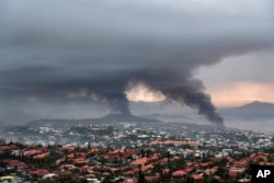 Smoke rises during protests in Noumea, New Caledonia, on May 15, 2024.