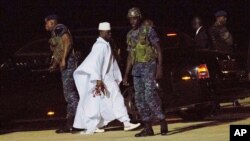 FILE - Gambia's former leader Yahya Jammeh, in white, is seen at Banjul airport, Gambia. Taken Jan. 21, 2017. 