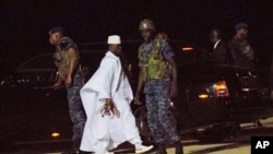 FILE - Gambia's former leader Yahya Jammeh, in white, is seen at Banjul airport, Gambia, Jan. 21, 2017. 