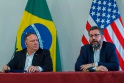 U.S. Secretary of State Mike Pompeo listens to Brazilian Foreign Minister Ernesto Araujo speaking during a press conference at the Boa Vista Air Base in Roraima, Brazil, Sept. 18, 2020.