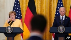President Joe Biden and German Chancellor Angela Merkel listen to a question during a news conference in the East Room of the White House in Washington, July 15, 2021.