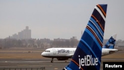 FILE - An A320 Jet Blue plane taxis at JFK airport in New York, March 28, 2014. 