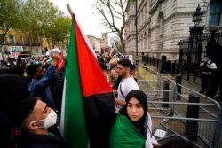 People gather outside Downing Street to protest against Israeli attacks on Palestinians in Gaza, in London, May 15, 2021.