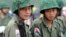 Two young Karen soldiers guard his jungle camp of Mi Aye Bo in Burma's Karen state near the Thai border during a Karen New Year celebration, December 23, 2003. 