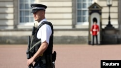 A police officer patrols the grounds of Buckingham Palace in London, Britain, Aug. 26, 2017, after a sword attack the previous day. 