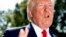 President Donald Trump speaks to members of the media on the South Lawn of the White House in Washington, July 12, 2019, before Trump boards Marine One for a short trip to Andrews Air Force Base, Md. 