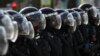 FILE - Police block a street during an unsanctioned rally in the center of Moscow, Russia, Aug. 3, 2019.