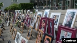 Portraits of Syrian detainees are seen at Koblenz court in Germany where trials started last June of two people alleged to be former Syrian intelligence officials involved in crimes against humanity inside Syrian prisons. (Courtesy: Maimouna al-Ammar)
