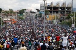 FILE - Protesters fill the road leading from Delmas toward Petion-Ville, during a mostly peaceful protest called by the artist community in Port-au-Prince, Haiti, Oct. 20, 2019.