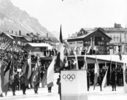 FILE - Italian Alpine skier Giuliana Chenal-Minuzzo reads the Olympic oath, on behalf of all the athletes taking part, at the opening ceremony of the seventh Winter Olympic Games, at Cortina, Italy, Jan.26, 1956.