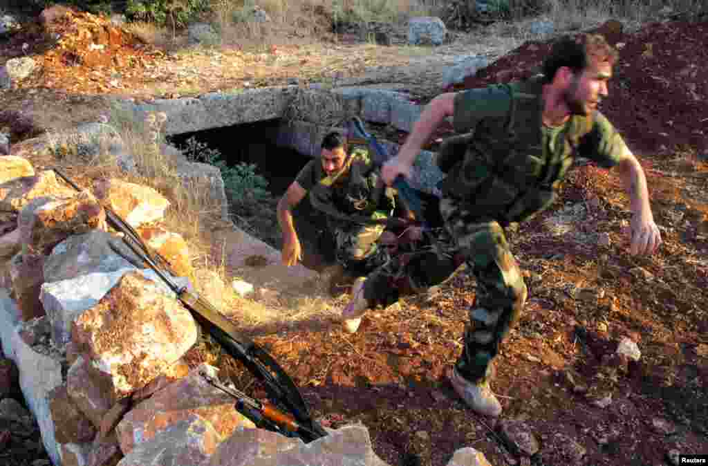 Dua tentara anggota Lasykar Pembebasan Suriah - dari&nbsp; kelompok Brigade Farouq - melakukan latihan militer di Sarmada, dekat provinsi Idlib (9/7).