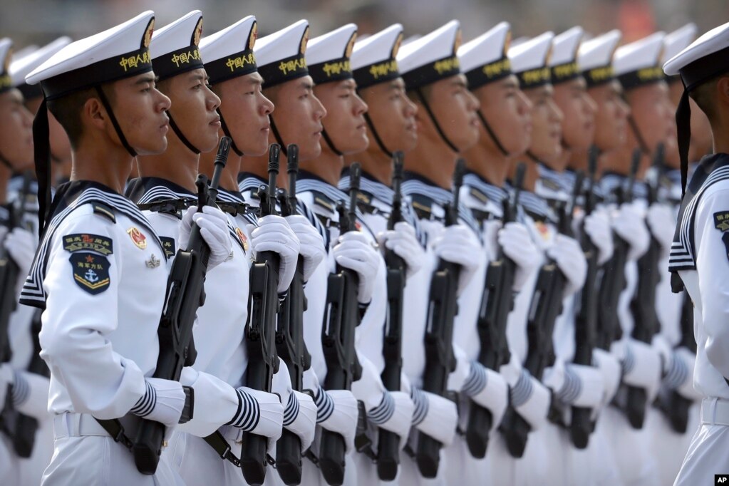Soldiers from China's People's Liberation Army (PLA) Navy march in formation during a parade to commemorate the 70th anniversary of the founding of Communist China in Beijing, Tuesday, Oct. 1, 2019.