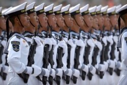 Soldiers from China's People's Liberation Army (PLA) Navy march in formation during a parade to commemorate the 70th anniversary of the founding of Communist China in Beijing, Tuesday, Oct. 1, 2019.