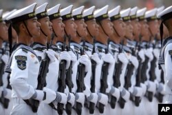 Soldiers from China's People's Liberation Army (PLA) Navy march in formation during a parade to commemorate the 70th anniversary of the founding of Communist China in Beijing, Tuesday, Oct. 1, 2019.