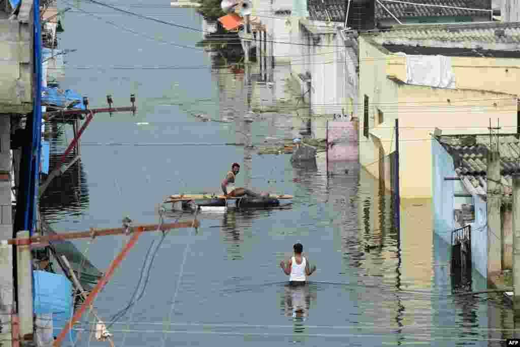 Flood-affected residents search for their belongings following heavy rains on the outskirts of Hyderabad, India.