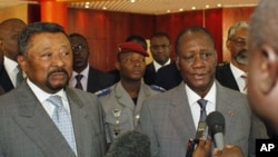 Ivory Coast's internationally-recognized President, Alassane Ouattara, right, addresses journalists following a meeting with African Union commission chairman Jean Ping, left, at the Golf Hotel in Abidjan, Ivory Coast, March 5, 2011