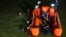 Rescuers search for drowning victims in a river in Ciamis, West Java, Indonesia, Oct. 15, 2021.