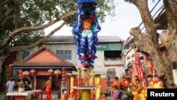 Lion dancers prepare for performances ahead of the Lunar New Year celebrations at a temple in Phnom Penh, Cambodia, January 26, 2022. Picture taken January 26, 2022. REUTERS/Cindy Liu